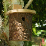 Natural Log Bird Nester (Green) - The Irish Gardener Store Natural Log Bird Nester, rustic wooden design with natural bark exterior, green-painted slanted roof, circular entrance hole for small birds, eco-friendly bird nesting box, ideal for garden and outdoor use, wildlife-friendly habitat