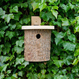 Natural Log Bird Nester (Green) - The Irish Gardener Store Natural Log Bird Nester, rustic wooden design with natural bark exterior, green-painted slanted roof, circular entrance hole for small birds, eco-friendly bird nesting box, ideal for garden and outdoor use, wildlife-friendly habitat