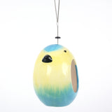 Ceramic Blue Tit Bird Feeder, bird-shaped design in vibrant blue and yellow colors, sleek ceramic finish, open entrance for easy bird access, suspended with a durable hanging wire, modern and stylish garden accessory