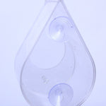 Transparent dewdrop-shaped window bird feeder, made of clear acrylic, featuring two suction cups for secure window attachment, lightweight and modern design, rope accent for optional hanging, empty open tray design, minimalistic bird feeder style