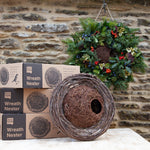 Simon King Wreath Nester - The Irish Gardener Store Simon King Wreath Nester made of natural twigs and branches, rustic bird nester attached to a stone wall, eco-friendly wildlife habitat, handcrafted wreath design, perfect for small birds, sustainable nesting solution, outdoor decorative garden feature, natural woven structure, ideal for birdwatching enthusiasts