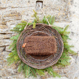 Simon King Wreath Nester - The Irish Gardener Store Simon King Wreath Nester made of natural twigs and branches, rustic bird nester attached to a stone wall, eco-friendly wildlife habitat, handcrafted wreath design, perfect for small birds, sustainable nesting solution, outdoor decorative garden feature, natural woven structure, ideal for birdwatching enthusiasts