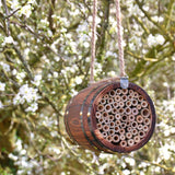 The Bee Barrel - The Irish Gardener Store rustic wooden bee barrel, hanging pollinator habitat, bamboo nesting tubes, eco-friendly design, bee nesting barrel, garden decoration for pollinators, sustainable bee shelter, wildlife garden accessory, wooden barrel bee home, rope hanging bee habitat