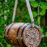 The Bee Barrel - The Irish Gardener Store rustic wooden bee barrel, hanging pollinator habitat, bamboo nesting tubes, eco-friendly design, bee nesting barrel, garden decoration for pollinators, sustainable bee shelter, wildlife garden accessory, wooden barrel bee home, rope hanging bee habitat