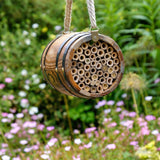 The Bee Barrel - The Irish Gardener Store rustic wooden bee barrel, hanging pollinator habitat, bamboo nesting tubes, eco-friendly design, bee nesting barrel, garden decoration for pollinators, sustainable bee shelter, wildlife garden accessory, wooden barrel bee home, rope hanging bee habitat