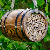 The Bee Barrel - The Irish Gardener Store rustic wooden bee barrel, hanging pollinator habitat, bamboo nesting tubes, eco-friendly design, bee nesting barrel, garden decoration for pollinators, sustainable bee shelter, wildlife garden accessory, wooden barrel bee home, rope hanging bee habitat
