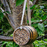 The Bee Barrel - The Irish Gardener Store rustic wooden bee barrel, hanging pollinator habitat, bamboo nesting tubes, eco-friendly design, bee nesting barrel, garden decoration for pollinators, sustainable bee shelter, wildlife garden accessory, wooden barrel bee home, rope hanging bee habitat