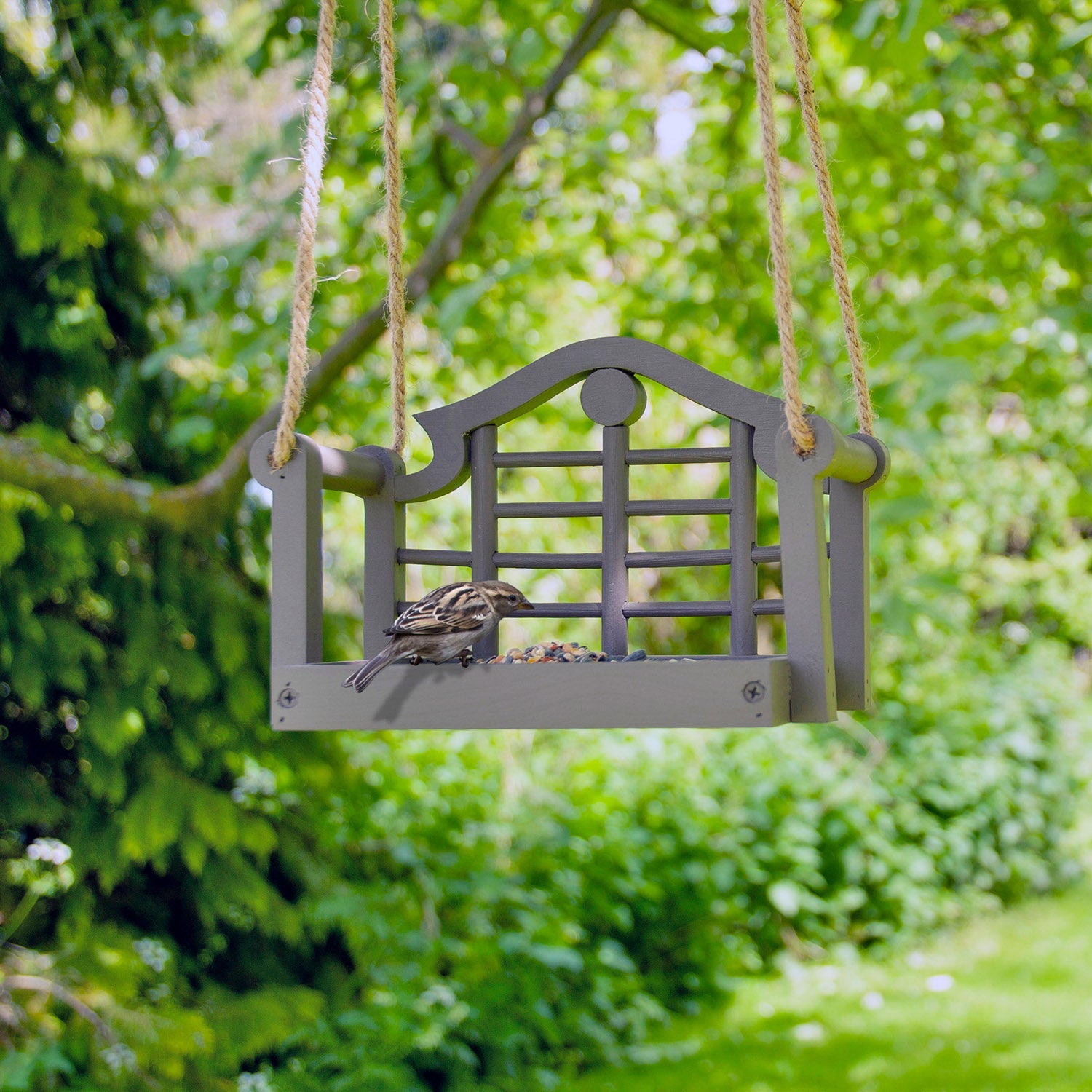 Timeless Lutyens Swingseat Bird Feeder - The Irish Gardener Store Timeless Lutyens Swingseat Bird Feeder hanging in a garden, wooden swing design for feeding birds, durable rope suspension, classic Lutyens-inspired style, weather-resistant bird feeder, decorative garden bird feeder, close-up of wooden swing bird feeder, perfect for small birds like sparrows and finches, garden wildlife attraction, stylish bird feeder for outdoor spaces