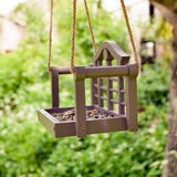Timeless Lutyens Swingseat Bird Feeder - The Irish Gardener Store Timeless Lutyens Swingseat Bird Feeder hanging in a garden, wooden swing design for feeding birds, durable rope suspension, classic Lutyens-inspired style, weather-resistant bird feeder, decorative garden bird feeder, close-up of wooden swing bird feeder, perfect for small birds like sparrows and finches, garden wildlife attraction, stylish bird feeder for outdoor spaces