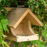 "Blackbird Nest Box, wooden open-front design, natural untreated timber, nestled among green ivy leaves, sloped roof for weather protection, eco-friendly bird nesting box, ideal for blackbirds and garden wildlife"