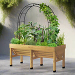 Sturdy black metal garden arch with climbing plants growing over it, positioned between two wooden raised beds filled with lush vegetables and flowers in a beautifully maintained garden.