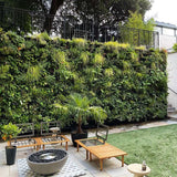 Outdoor patio featuring a large PlantBox Living Wall System filled with lush greenery, creating a stunning vertical garden as a natural backdrop., Plant Box Living Wall System - The Irish Gardener Store