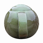 Robin Teapot Nester - The Irish Gardener Store Robin Teapot Nester, ceramic teapot-shaped birdhouse, green glaze finish, rounded design, open-top entrance, durable and weatherproof material, eco-friendly bird shelter, ideal for robins and small birds, decorative garden feature, unique wildlife habitat, standalone view