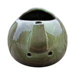 Robin Teapot Nester - The Irish Gardener Store Robin Teapot Nester, ceramic teapot-shaped birdhouse, green glaze finish, rounded design, open-top entrance, durable and weatherproof material, eco-friendly bird shelter, ideal for robins and small birds, decorative garden feature, unique wildlife habitat, standalone view