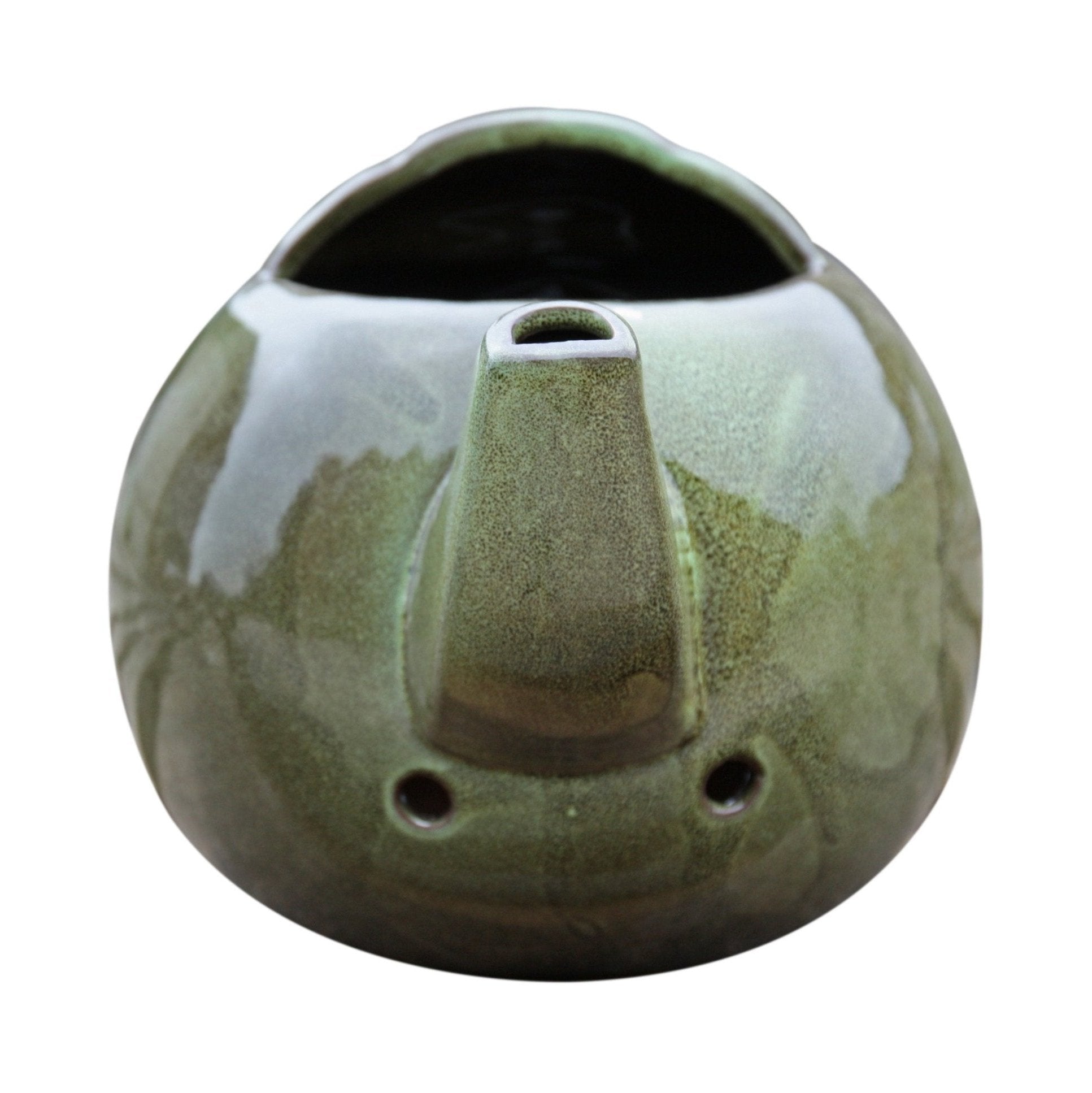 Robin Teapot Nester - The Irish Gardener Store Robin Teapot Nester, ceramic teapot-shaped birdhouse, green glaze finish, rounded design, open-top entrance, durable and weatherproof material, eco-friendly bird shelter, ideal for robins and small birds, decorative garden feature, unique wildlife habitat, standalone view