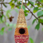 Tahera - Artisan Bird Nester - The Irish Gardener Store handcrafted Tahera Artisan Bird Nester, eco-friendly woven bird house, vibrant natural fiber bird nester, sustainable bird shelter with colorful design, cone-shaped hanging bird nester, rustic garden birdhouse, artisan-crafted nesting habitat