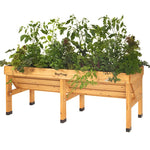 VegTrug - The Irish Gardener Store, Wooden raised garden bed filled with lush green plants and herbs,
VegTrug wooden planter box with vegetables and herbs growing,
Elevated wooden garden bed for planting herbs and vegetables,
Rectangular wooden planter on legs, designed for gardening,
Raised planter box made of natural wood, showcasing vibrant plants.